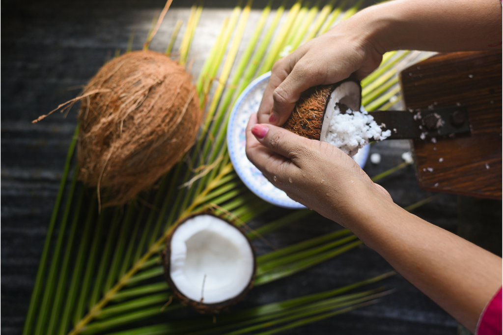 Woman grates coconut in Kerala, India