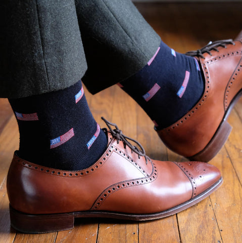 American flag patterned dress socks with dark flannel trousers and brown oxfords