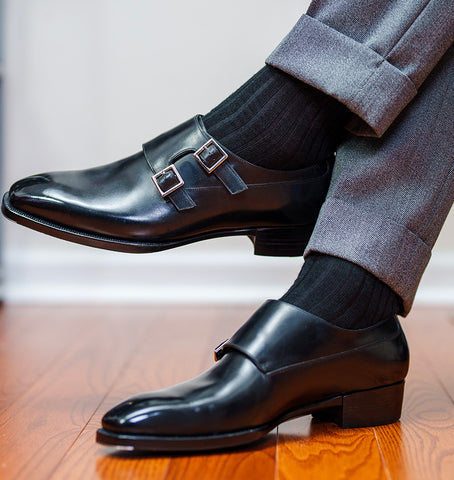 man crossing legs wearing outfit and black socks for church