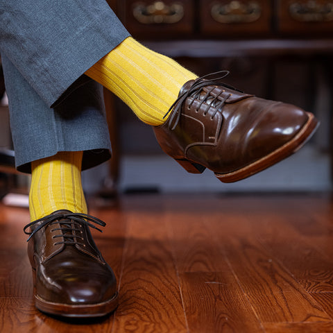 yellow dress socks with light grey trousers and brown dress shoes