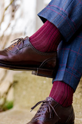 burgundy dress socks with a navy and burgundy patterned suit