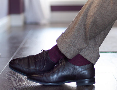 burgundy socks paired with a light brown suit