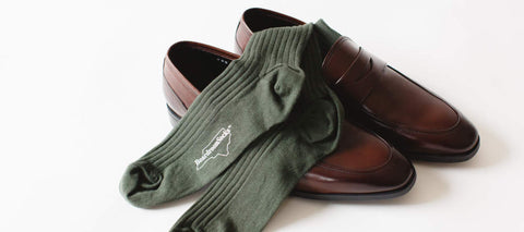 olive green cotton dress socks folded inside dark brown penny loafers