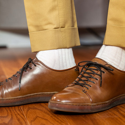 man wearing cream dress socks with dark tan chinos and brown leather dress shoes