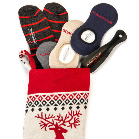 socks and shoe horn going into a holiday stocking