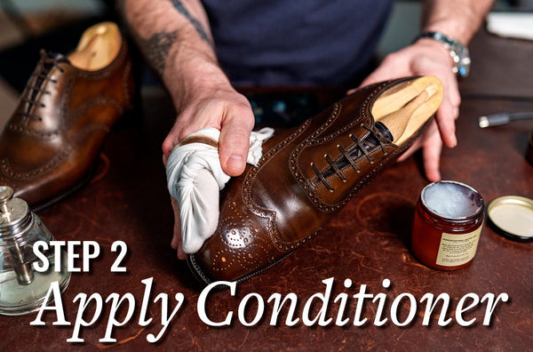 applying conditioner to a pair of dark brown oxford dress shoes