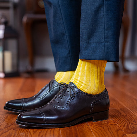 yellow dress socks paired with a navy suit and dark brown oxfords