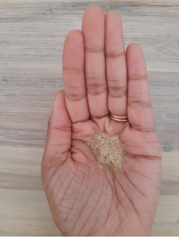 womans palm showing the light colored powder mixed with water