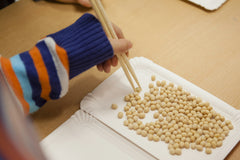 A child using chopsticks.