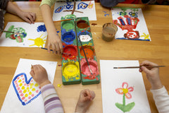 Art supplies plus child painting.