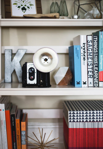 shelving with no mat or liner on it, holding books and decor