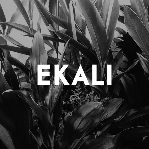 An image of the word "Ekali" written over top of a black and white image of a close-up plant.