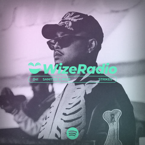 An image of the DJ and playlist creator wearing a black hoodie and a black baseball cap and wearing sunglasses. Over his chest is written WizeRadio in green text.