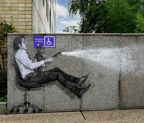 Another larger-than-life-size image of street art featuring a man in a desk chair rocketing backward while spraying a fire extinguisher.