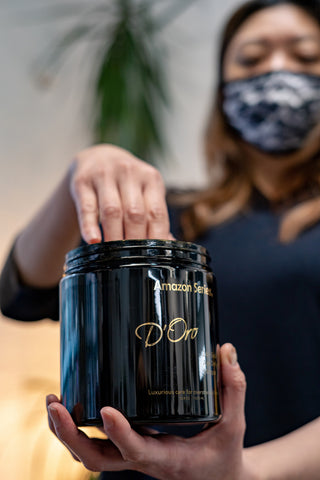 A Vancouver hairstylist dips her hand into a container of the Amazon D'Oro hair masque found at Fine Edge Supply
