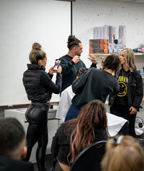 Professional barber and educator, Dro, demonstrating hair cutting techniques in Vancouver