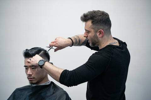 Professional barber, Ricardo, demonstrates a haircut in front of a crowd