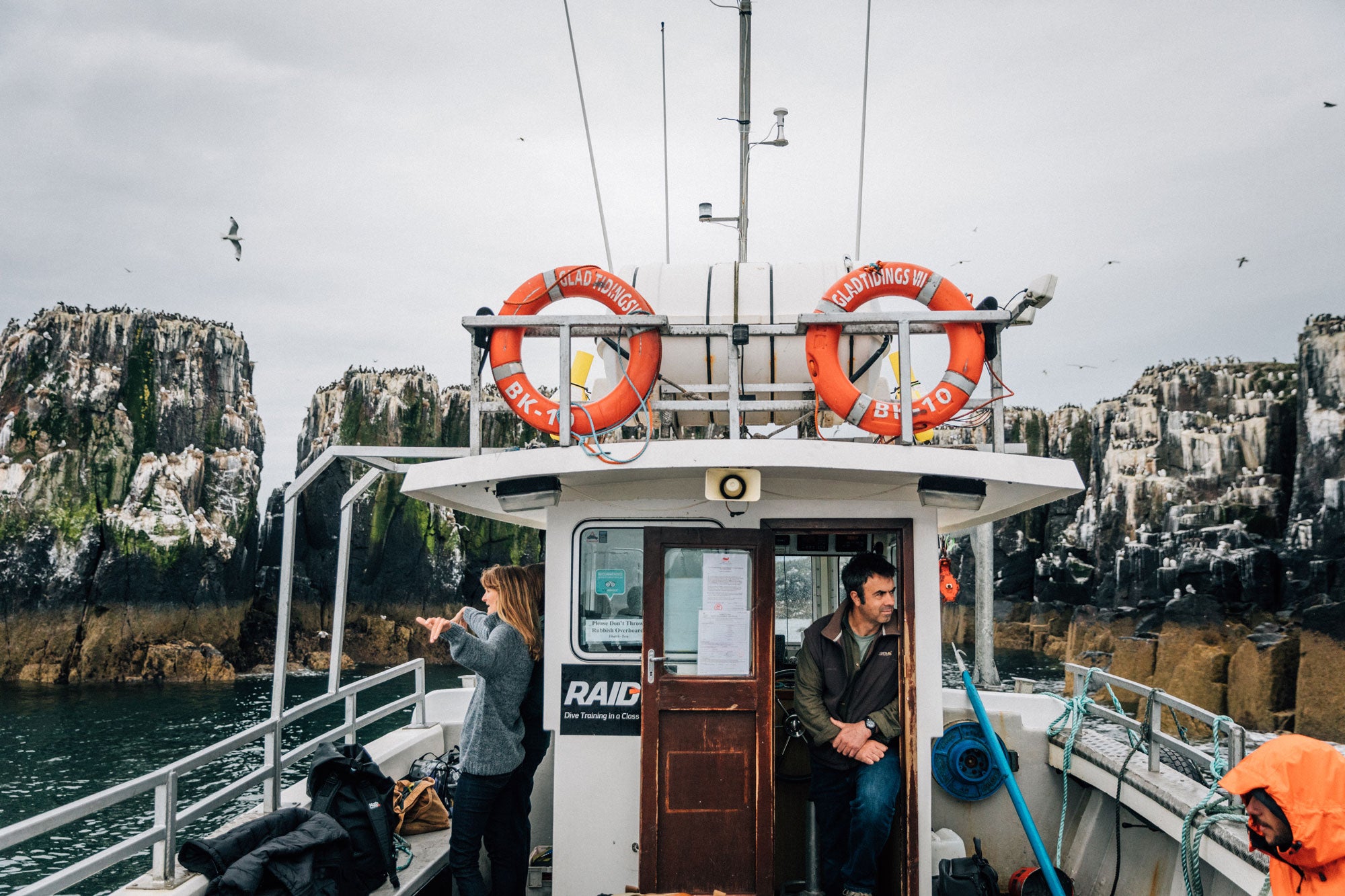 finisterre-crew-bobbing-on-a-boat-by-the-cliffs-of-the-farne-islands