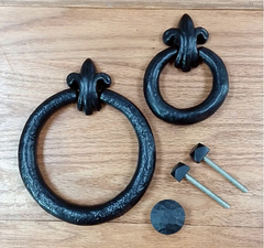 2 old world-style iron ring pulls with decorative bolts and a screw-on strike