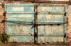 Blue garage door covered in rust.