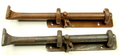 Two cane bolts. One is oxidized, the other is unfinished.