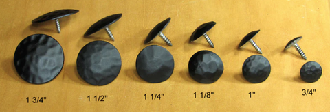 A line of screw nails, arranged from largest to smallest