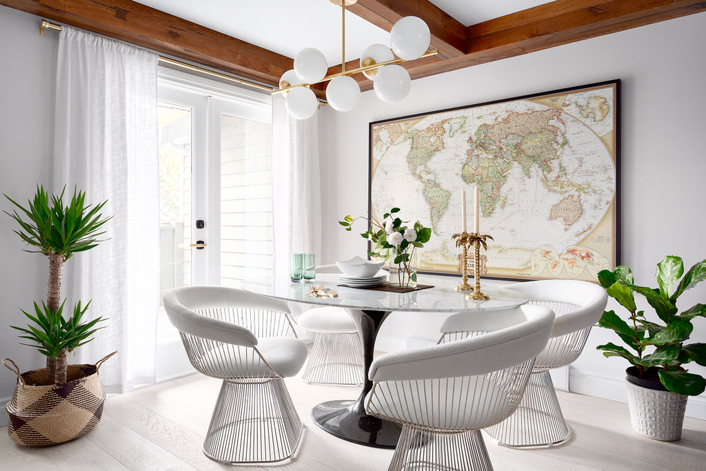 Engineered white oak flooring in a white stain in a dining room in the private townhouse of Karin Bohn with a large map on the wall