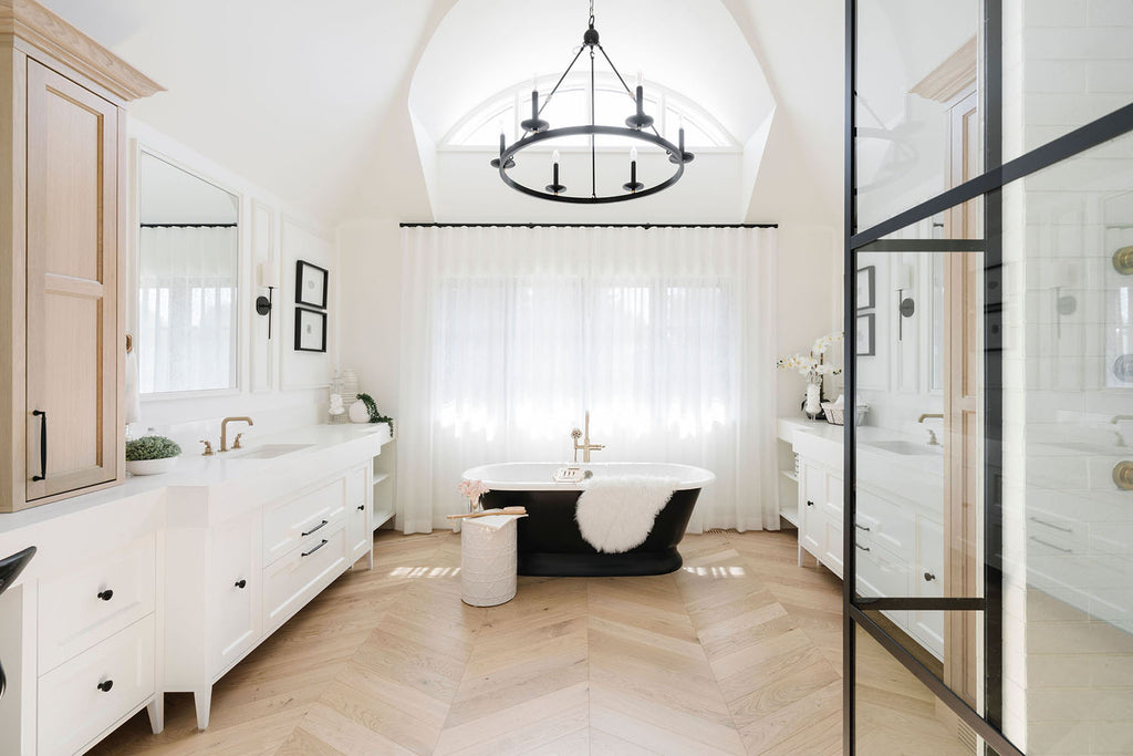 Chevron hardwood installed in a modern farmhouse ensuite designed by MartinLee Design of Calgary