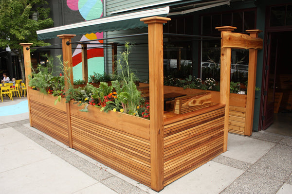 Self-Watering elevated restaurant garden. Cedar raised beds, container gardens, and veggie/vegetable gardens featuring GardenWell sub-irrigation to create wicking beds for growing your own food.