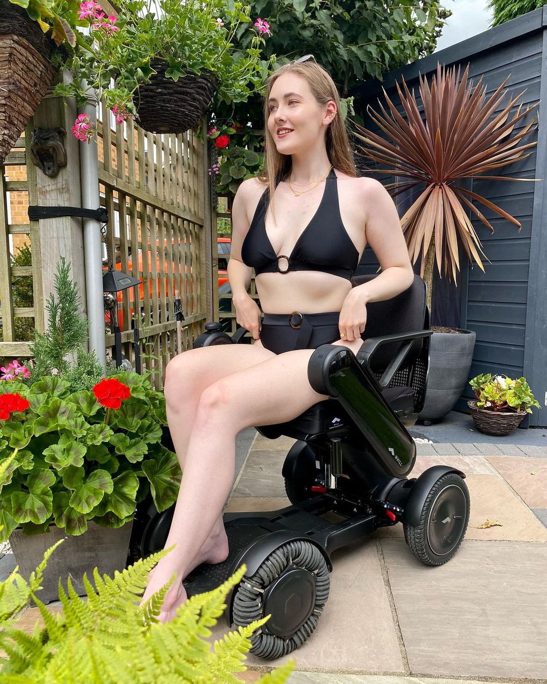Georgia is wearing the Jayne black bikini while using a wheelchair