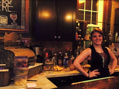 Picture of  a women standing in a kitchen dressed in a 1920 themed outfit