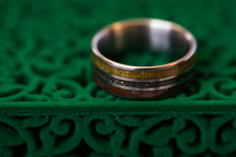 picture of The Jurassic wedding band on a green velveteen box. 