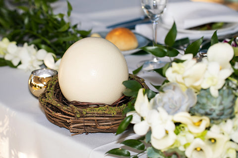 Picture of an ostrich egg sitting on a couple's sweetheart table