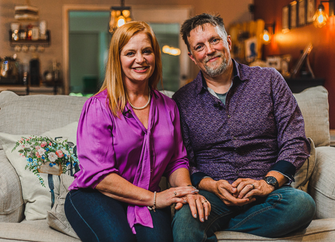 couple-posing-in-their-home-sitting-on-their-couch