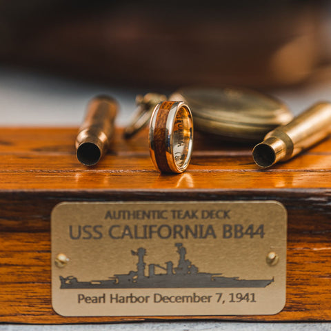 USS California teak ring with yellow gold on teak plank