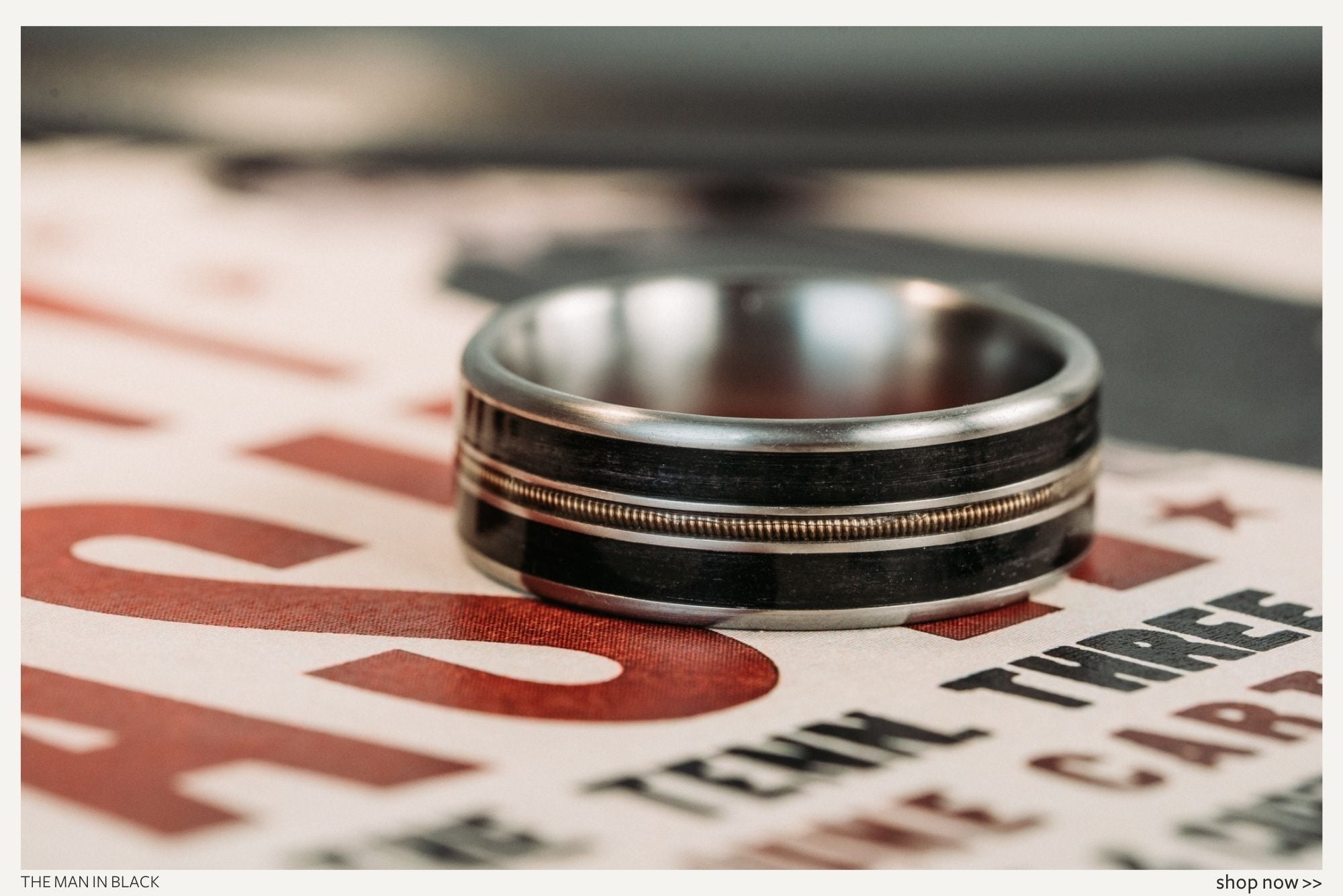 our-favorite-rugged-rustic-wedding-bands-for-him-titanium-weathered-whiskey-barrel-bronze-guitar-string-mens-wedding-band-man-in-black-rustic-and-main