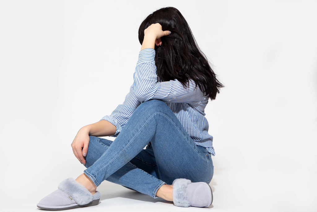 Woman sitting on floor wearing Nuknuuk slippers