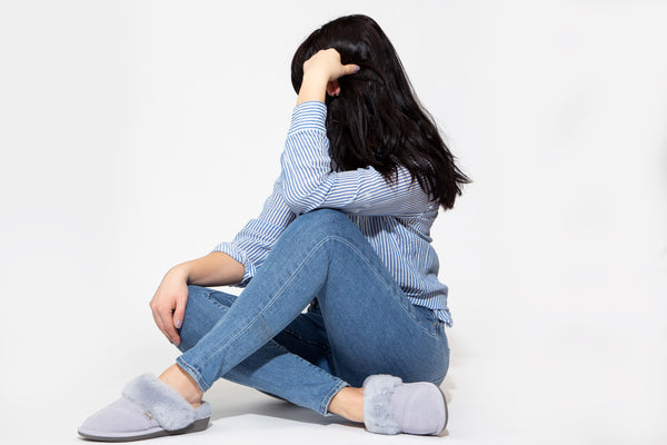 Woman sitting on floor wearing Nuknuuk slippers