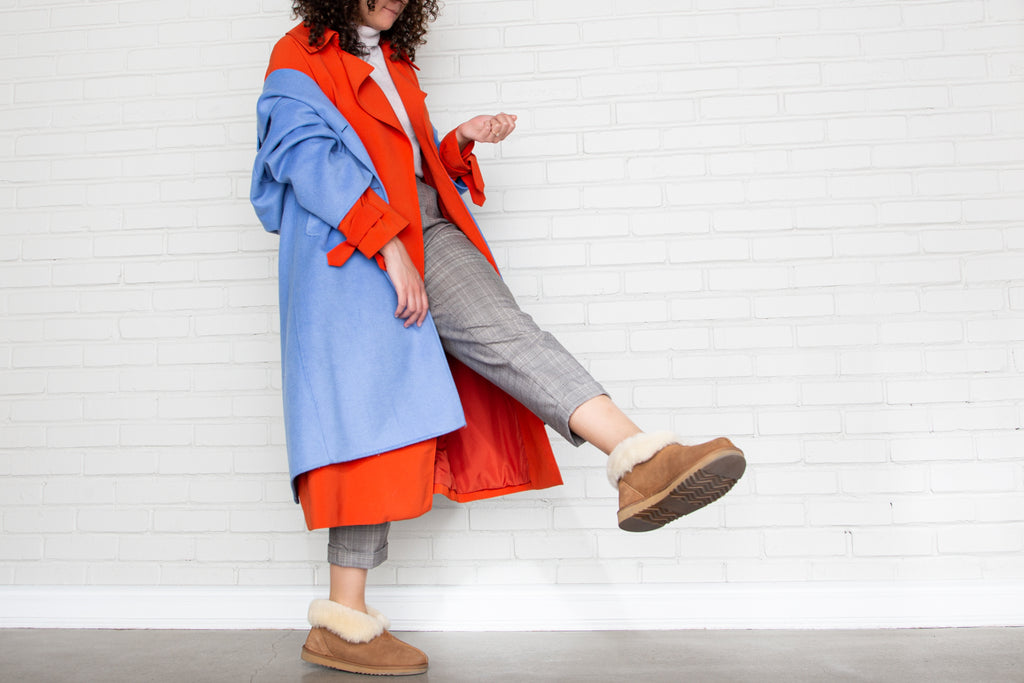 Woman kicking up foot in The Classic Nuknuuk Slipper