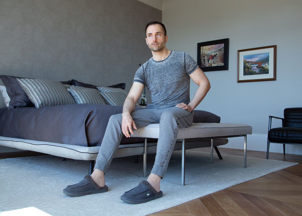 Man sitting on bench wearing slippers