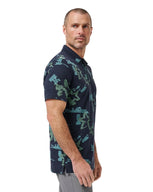 Man wearing a navy blue camouflage-patterned polo shirt on a white background