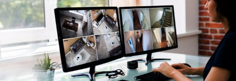 lady watching security cameras on two screens