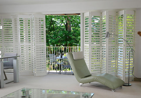 half open sliding white shutters in a modern room with