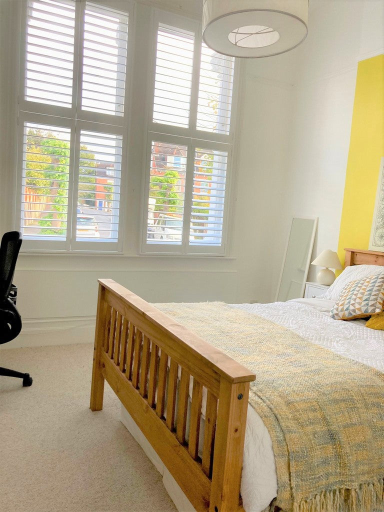 bedroom of a home in Crystal Palace with white wooden shutters on the window