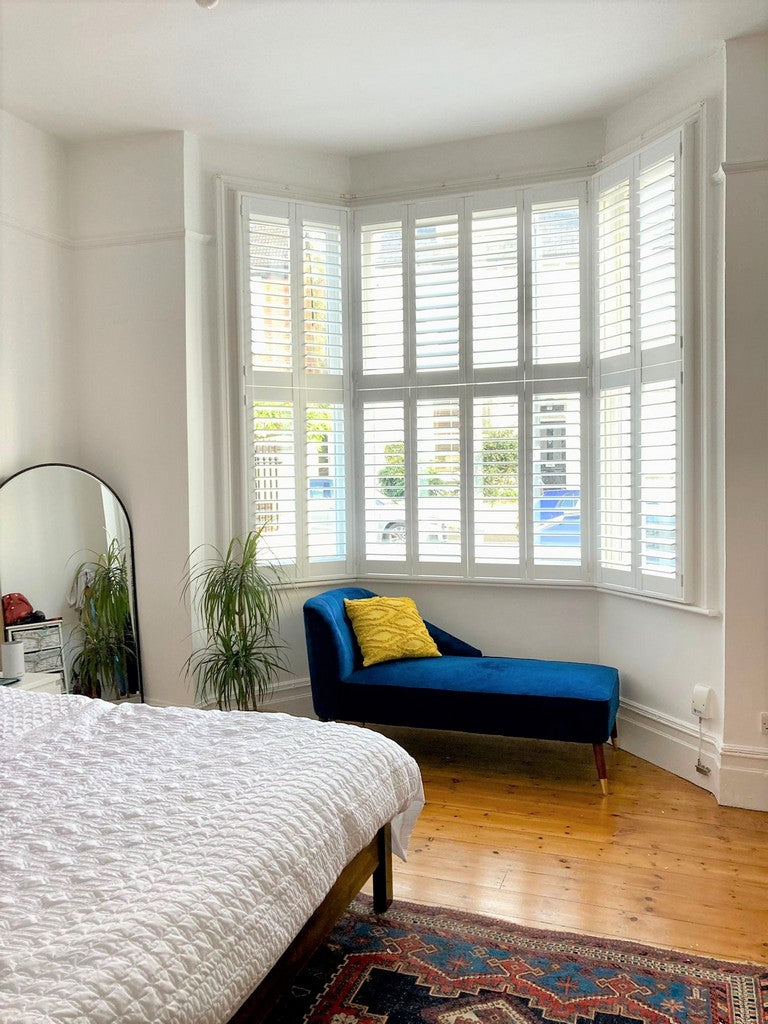 detail of a room with a large bay window with basswood shutters