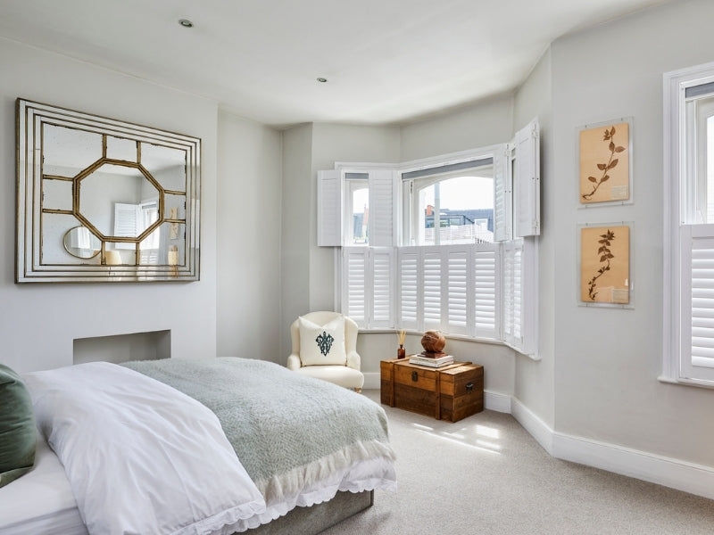 bedroom with tier on tier shutters