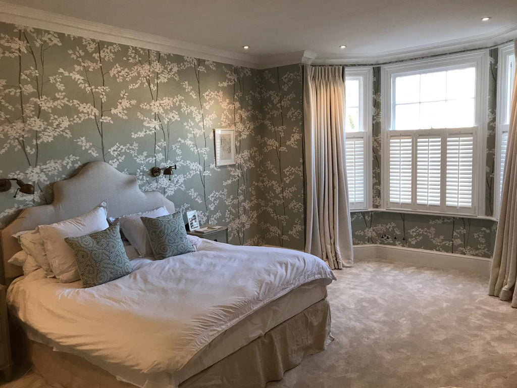 Elegant bedroom in Victorian property in Ealing with half height shutters on the window