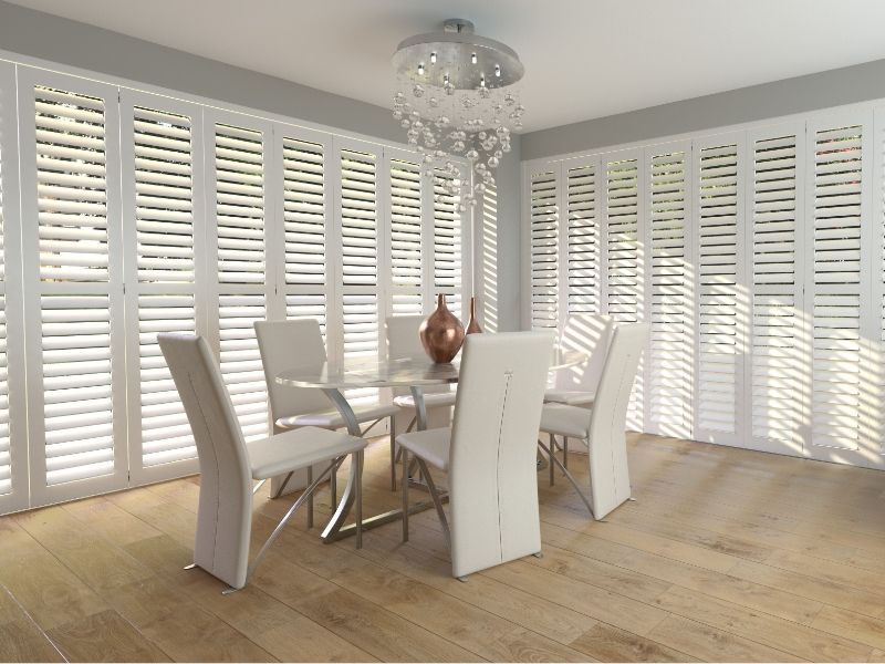 large windows with shutters in a dining room
