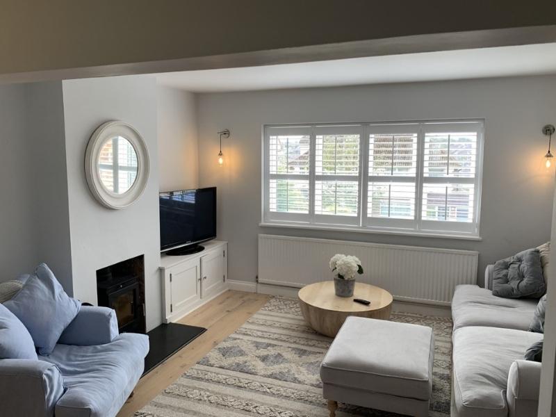 white mdf shutters in a living room in Hertfordshire house