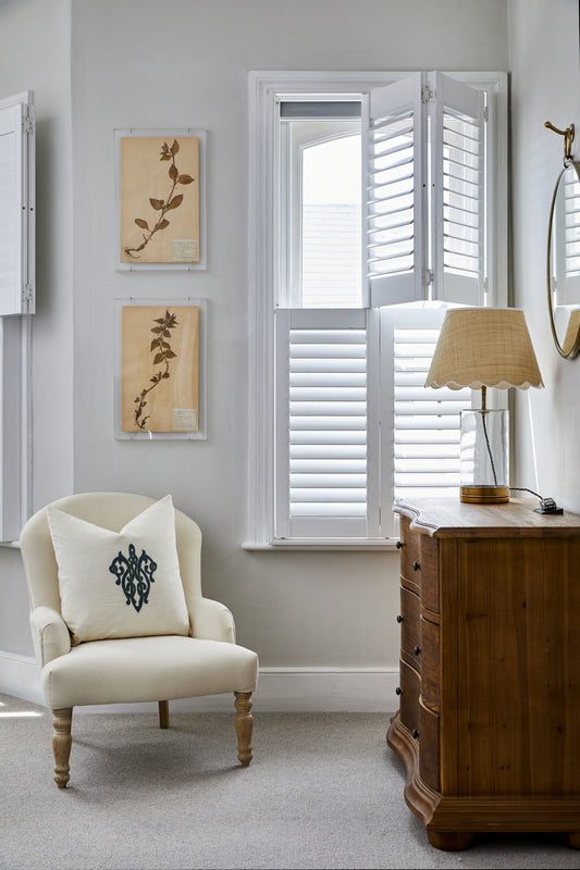 image of a small room with tier on tier shutters on the window